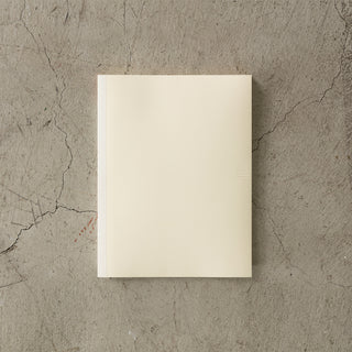 Beige notebook on a textured gray surface