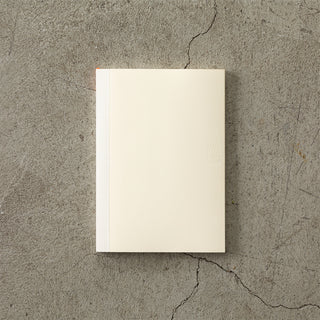 White notebook on a textured gray surface