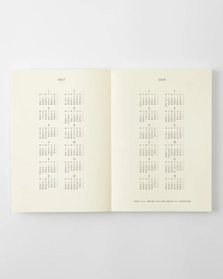 opened a5 planner with 2027 and 2028 year at a glance pages