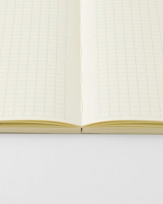 close up of grid notebook to show flat lay binding
