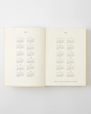 opened planner with 2027 and 2028 year at a glance pages
