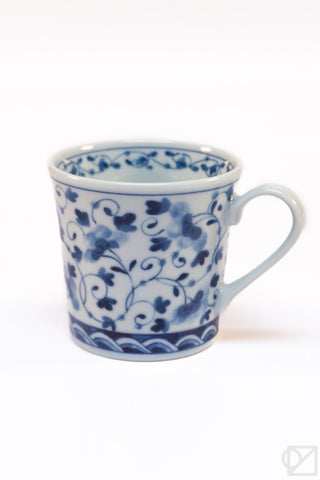 Ceramic mug with blue floral patterns on a white background