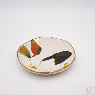Small ceramic plate with flower design on a white background