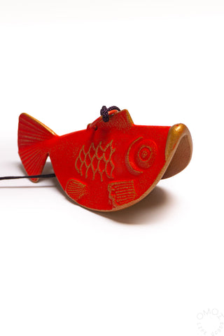 Red goldfish wind chime with textured body and hanging string