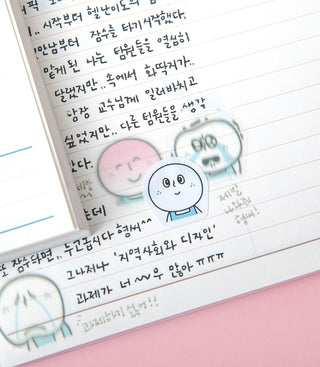 Notebook with handwritten text and stickers on a pink surface