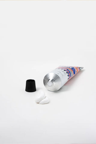 Silver tube with colorful label and black cap on a white background