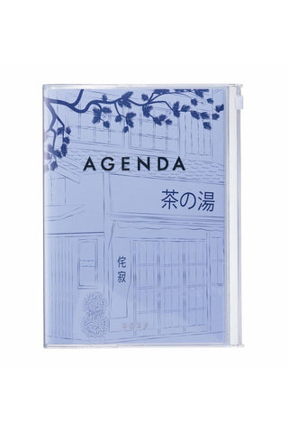 light blue planner with illustrated cover of outside of a shop with trees and has a zipper pocket