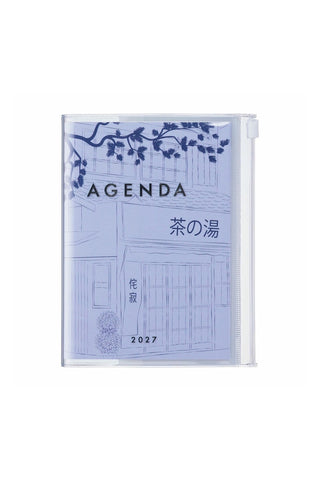 light blue planner with drawing of outside of a shop with trees