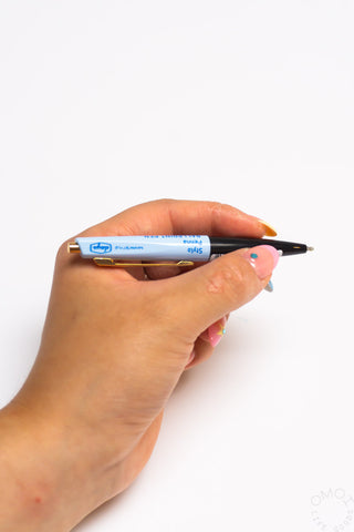 Hand holding a pen with a white background