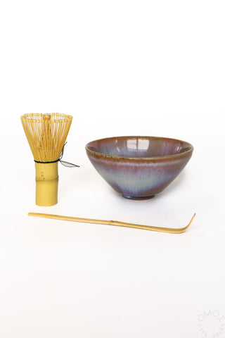 Ceramic bowl with a whisk and scoop on a white background
