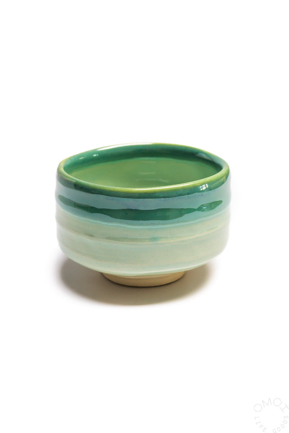 Seafoam ceramic matcha bowl with green rim and smooth curved sides