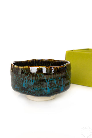 Ceramic bowl with blue glaze on a white background