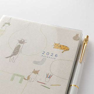 2026 datebook with cat illustrations and a pen on a white background