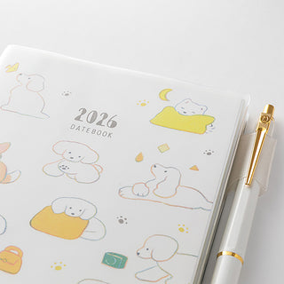 2026 datebook with cute dog illustrations and a pen on a white background