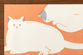 Stationery envelope with cat designs on an orange background