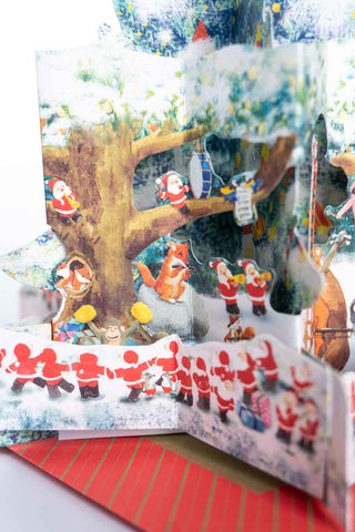 Pop-up Christmas card with mini santas and animals playing instruments.
