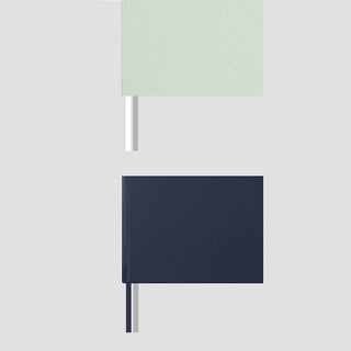 Two notebooks, mint green and navy, showing the different ribbon bookmarks it comes with