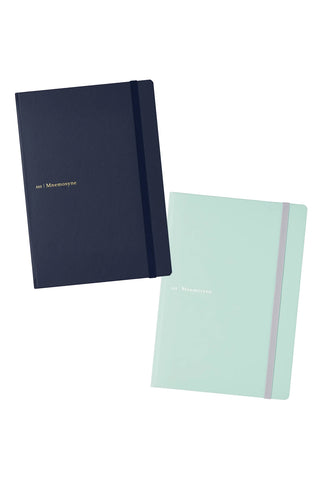 Two hardcover notebooks on a white background, one in dark navy blue and the other in pale mint green with a gray elastic band.