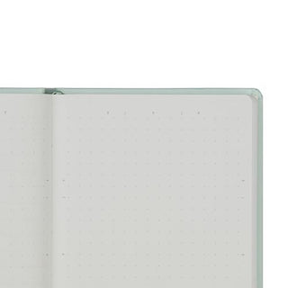 A close-up of an open notebook or planner with light dot grid page
