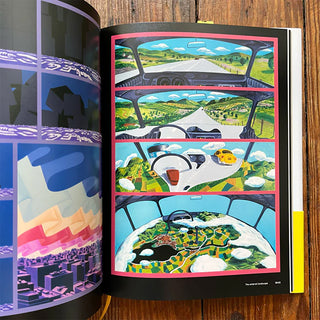 Open book with colorful illustrations of a car journey on a wooden surface