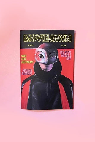 Magazine cover with a character in a black suit and mask on a pink background