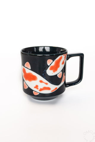 Dark blue mug with koi fish design on a white background