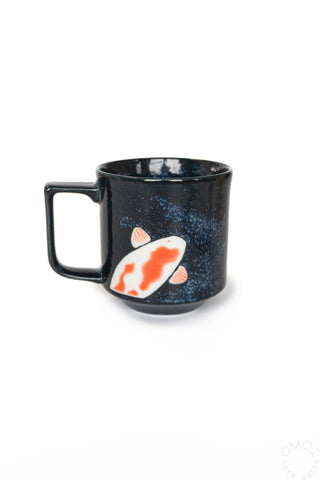 Dark blue mug with a fish design on a white background