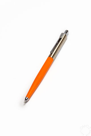 Pen with orange body and silver clip on a white background