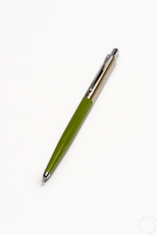 Green pen with silver accents on a white background