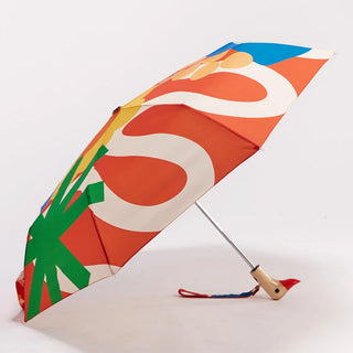 Compact open umbrella with multicolor abstract canopy and duck-style handle