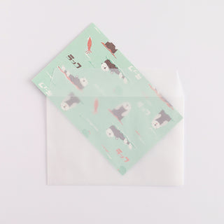 Folded paper with otter design sliding into envelope