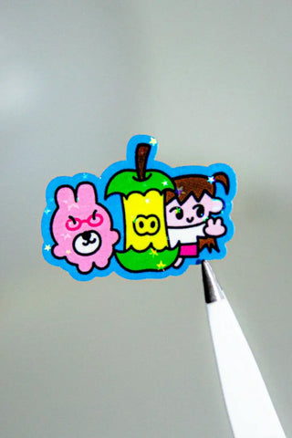 Colorful cartoon character sticker on a pen with a gray background