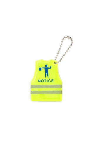 keychain shaped like a neon yellow high-visibility safety vest with reflective stripes and a blue 'NOTICE' icon, attached to a silver ball chain on a white background.