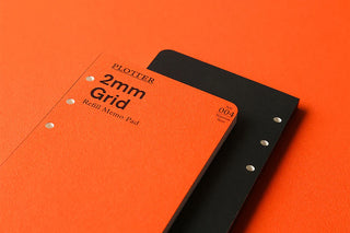 Two PLOTTER refill memo pads with '2mm Grid' text on an orange background