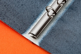 Close-up of rings on binder with textured surface