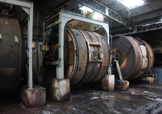 Large industrial barrels in a warehouse setting
