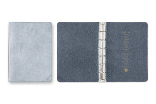 Blue binder with metal rings on a white background