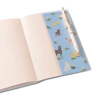 Paul & Joe planner opened to a blue animal-print inside cover with a matching pen