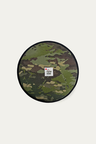 Camouflage-patterned round seat pad with a visible peace cabin logo on a white background