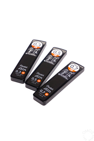 Three black Pentel lead pencil refills on a white background