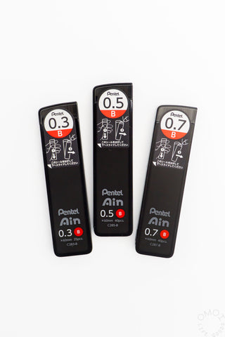 Three black Pentel Air lead refills with different tip sizes on a white background