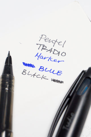 Two pens with text indicating color and brand on a white background