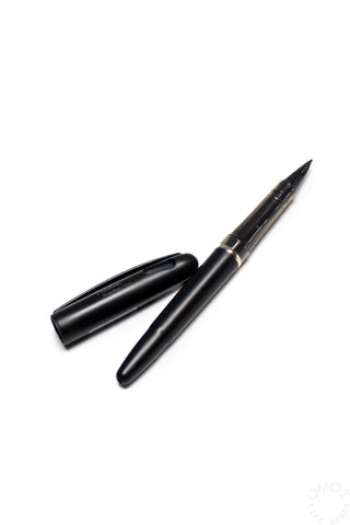 Black marker pen and cap on a white background