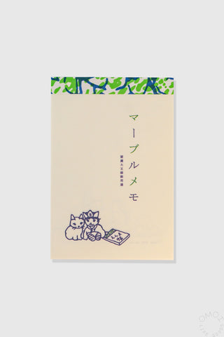 Notebook with cat illustrations and Japanese text on a beige background