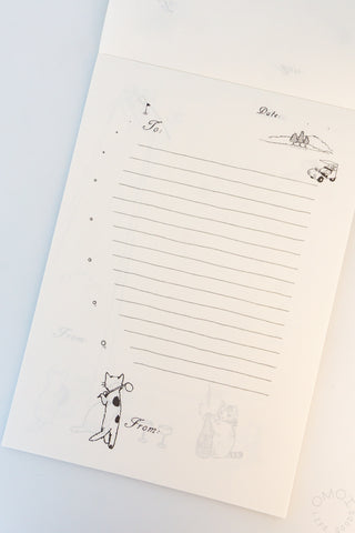 Memo pad page with illustration of cat golfing