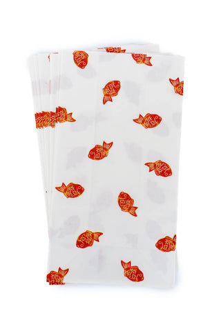 White paper bags with red fish patterns on a white background