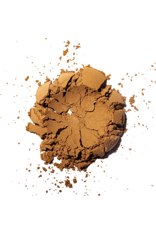 Brown hojicha powder on a white background