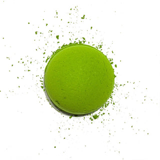 Matcha powder scooped into a circle on a white background