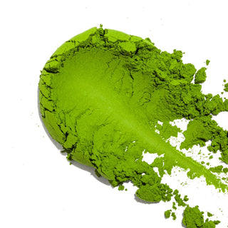 Matcha powder spread across a white background