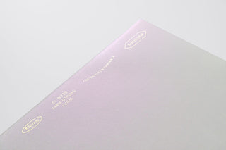 Light notebook with gold text on a light gray background